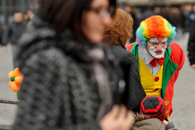 scary clown talks to a small child in Paris 